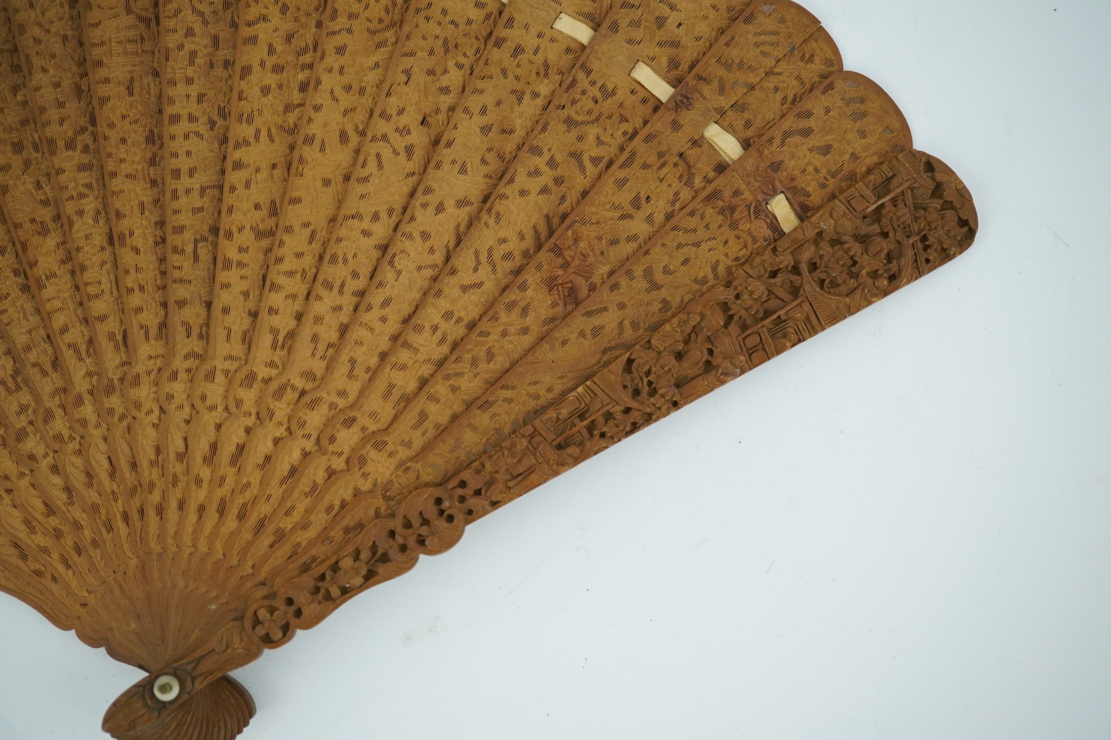 A fine Chinese sandalwood brise fan with finely carved sticks and guards, together with a mid 20th century silk calligraphic poetry LuYou fan, brise fan 38cm wide. Condition - minute damage to carving on one stick, sanda